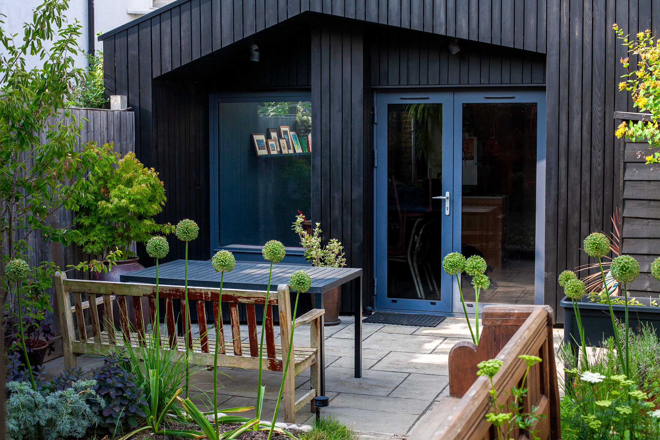 After retouch: distracting stacked chairs behind the glass doors have been removed for a cleaner composition.