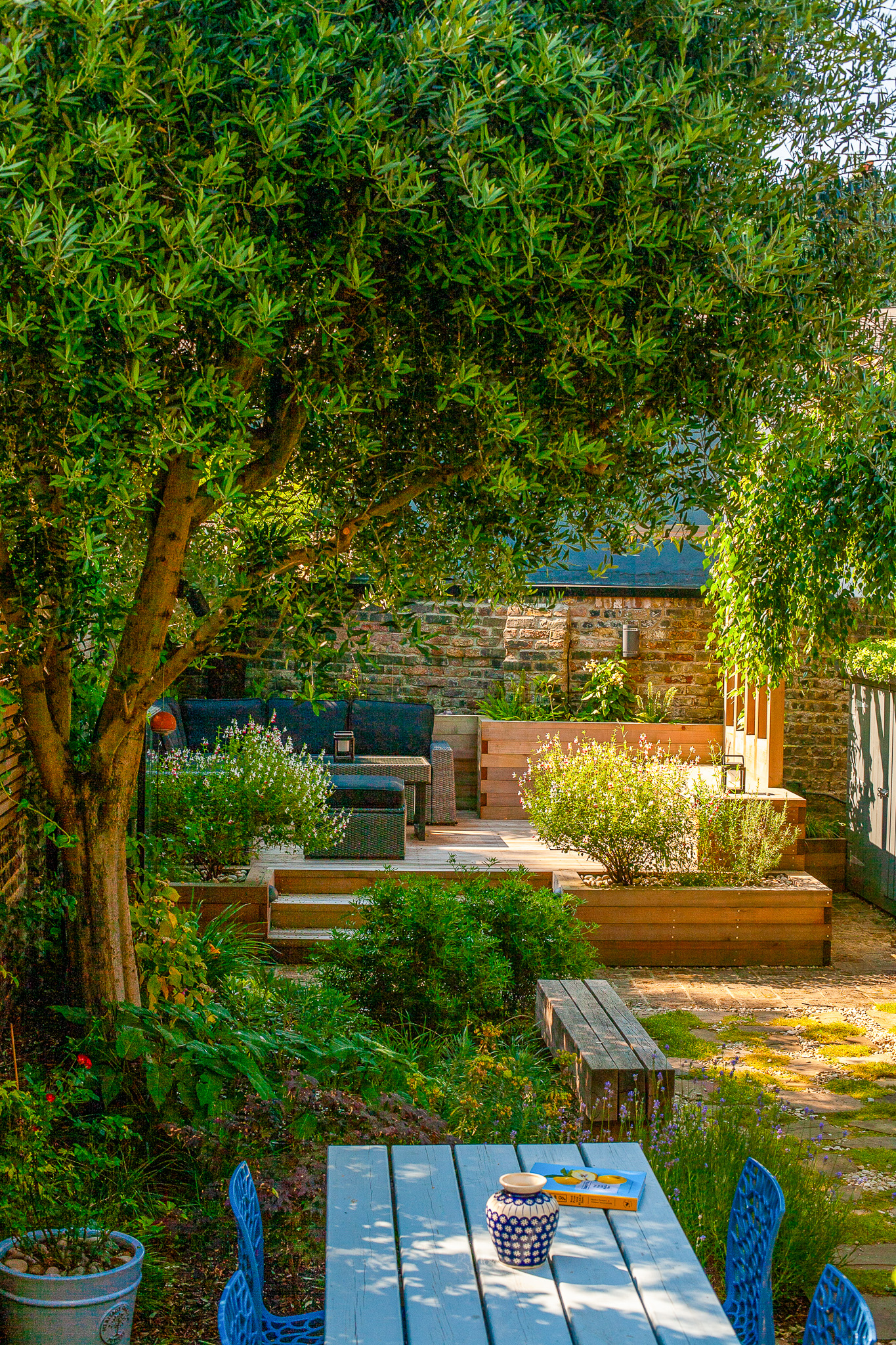 Courtyard garden design — Mediterranean feel, layered greenery, warm textures and natural light